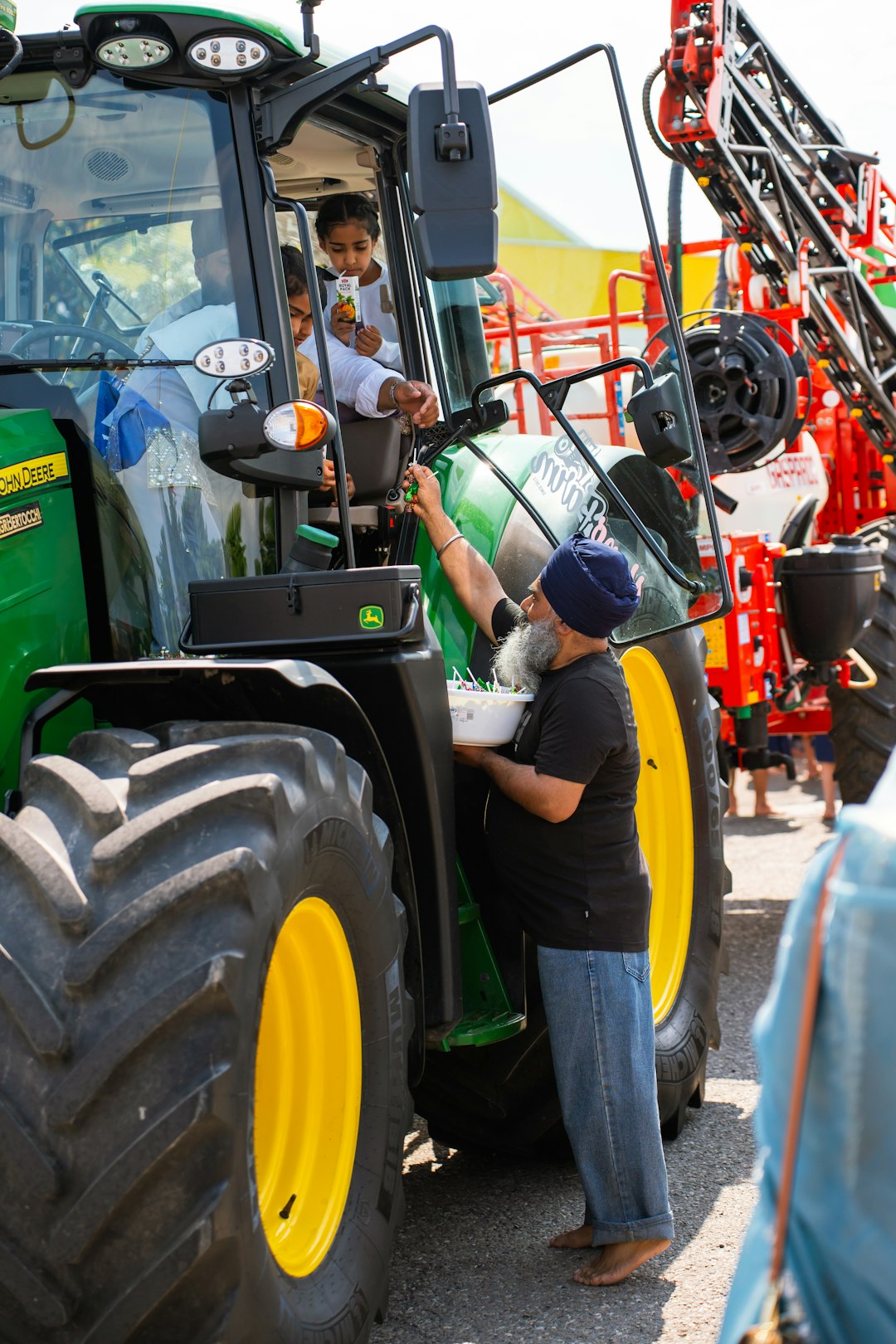 man-gives-food-to-children-in-tractor-osy4osjtzuc